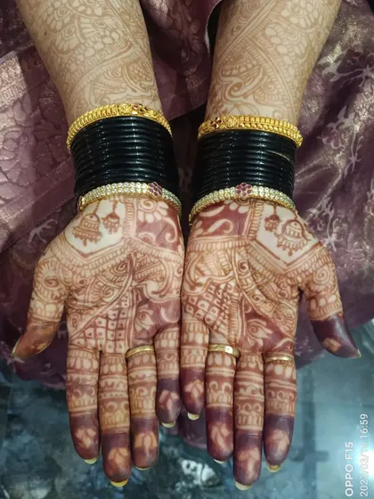 This is the result of using pure, organic henna: a rich, deep, and even stain. This photo shows the beautiful color of the mehendi after the paste has been removed, complemented by the bride's bangles.