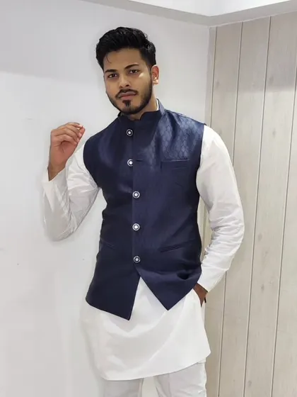 The classic Nehru jacket is incredibly versatile. I paired this simple white kurta-pajama with a structured navy blue jacquard jacket for a look that's perfect for a festive brunch, a family get-together, or a sangeet.