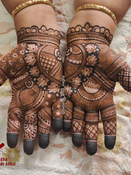 A personalized traditional design incorporating the name 'Vivanshi' within a central circle, surrounded by lotus and paisley patterns.