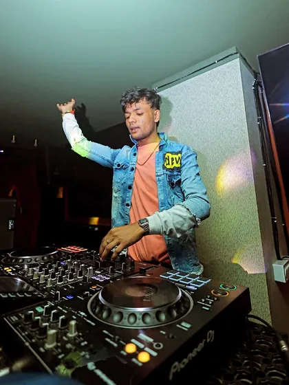 No competition, just a curated vibe. A shot of me in action, mixing tracks for a happy weekend crowd.