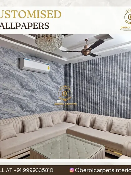 This living room combines a textured, grey marble-look wallpaper with vertically striped wallpaper for a sophisticated, multi-layered design.