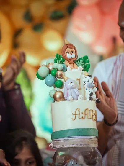 The best moment! The birthday girl and her family admiring the two-tier jungle cake. Creating these edible memories is what I love most.