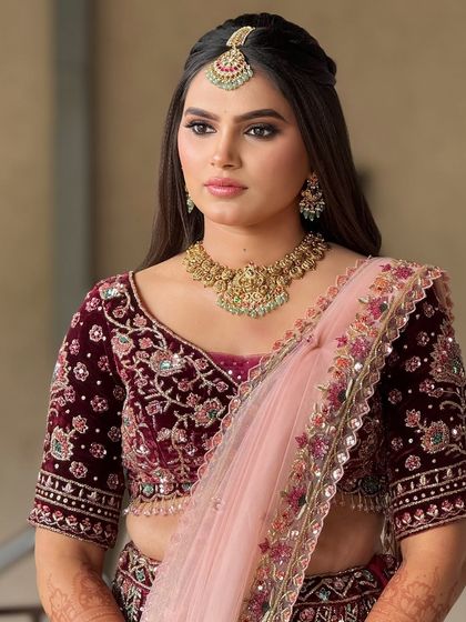A portrait of the bride in her velvet lehenga, her makeup looking sophisticated and elegant.