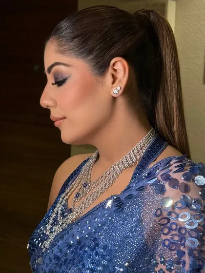 This sleek, high ponytail is a statement look for a modern bride, perfect for a Sangeet or reception. It's sharp, clean, and sophisticated, ensuring you can dance the night away without a hair out of place.