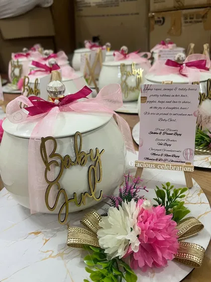 For a baby girl announcement, we use these lovely ivory handis with pink ribbons and a gold "Baby Girl" cutout. They are perfect for filling with traditional sweets to share your happy news.