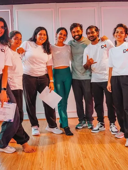 Our mentors and senior students posing together after the showcase. This picture represents the strong bond and collaborative spirit between our teachers and dancers.