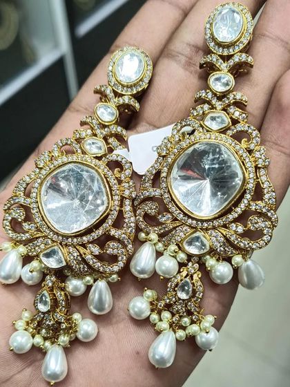 A pair of large polki earrings with American diamond detailing and pearl drops. These are very grand and perfect for a bride.