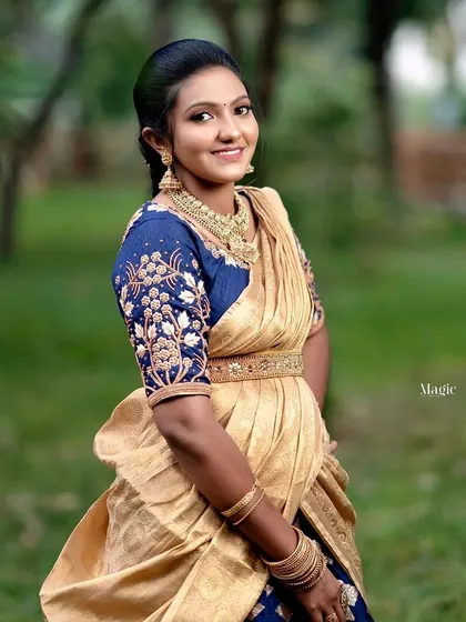 Our traditional half-saree rentals are perfect for engagements, housewarmings, and festive occasions. This golden half-saree is paired with a rich blue, intricately embroidered blouse for a timeless look.