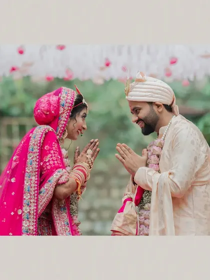 A sweet moment of greeting during the varmala ceremony, as the couple joins their hands in 'namaste'.