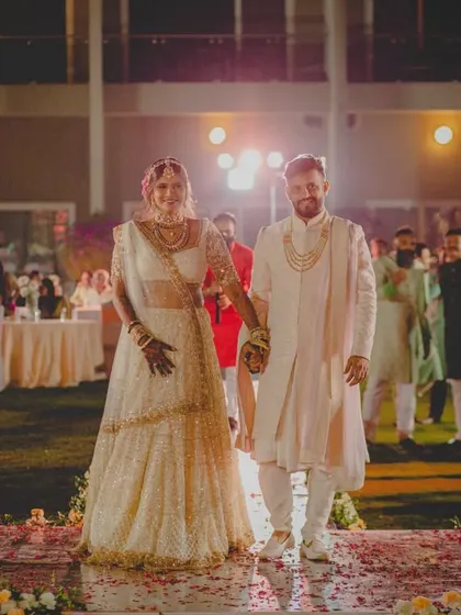 A beautiful shot of the couple walking down the aisle after their wedding ceremony at Radisson Karjat, ready to start their new life together.