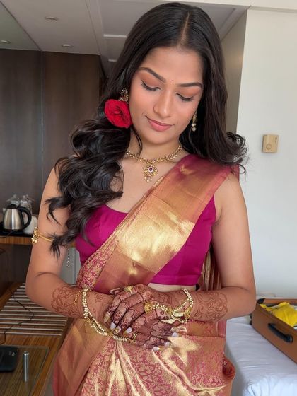 A beautiful portrait of a client in a traditional saree, her dark henna stain adding to the richness of her look.