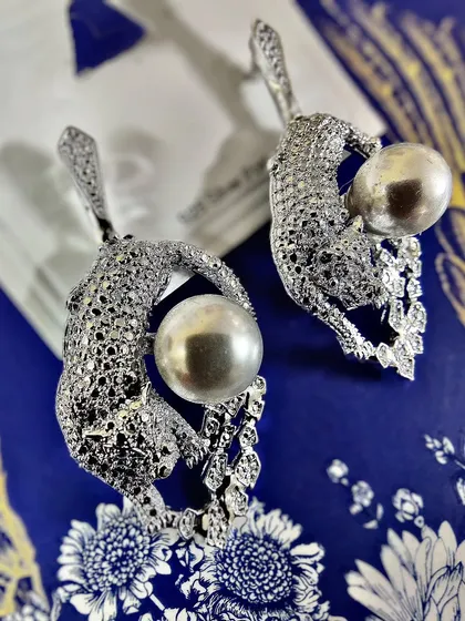 Unleash your wild side with these exquisite diamond-studded leopard earrings holding a lustrous pearl. This is a perfect example of my Feng Shui inspired collection, bringing together power and elegance in one statement piece.