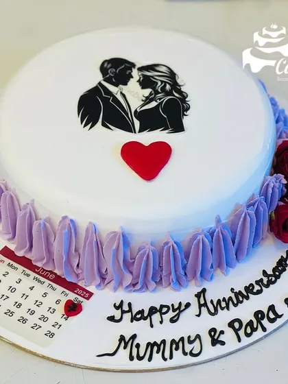 A sweet and simple anniversary cake for 'Mummy & Papa'. It features an edible print of a couple, a calendar marking their special day, and delicate purple piping.