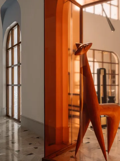 This wooden sculpture, housed in a deep amber glass case, is the 'pièce de résistance' of the main galleria. We placed it strategically to break the circulation spine and spark conversation, proving that art can add immense value and narrative to a space.