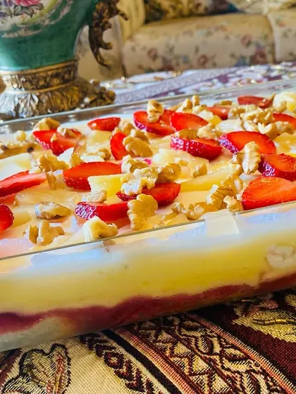 My fruit trifle is layers of pure happiness. I use moist cake, fresh strawberries, pineapple, crunchy walnuts, and a creamy custard to make this refreshing dessert.