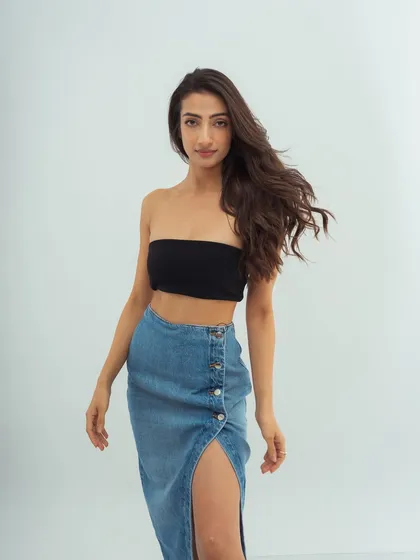 A simple, direct-to-camera shot. The clean makeup and casual styling create a fresh, approachable, and modern look.
