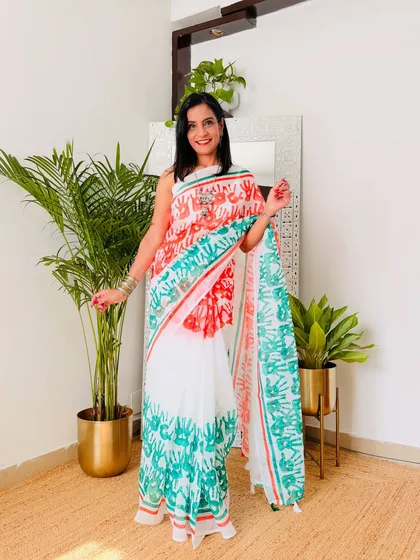 A fun and creative tricolor saree with handprints in saffron and green. This is a playful and unique design, perfect for school functions or community events.