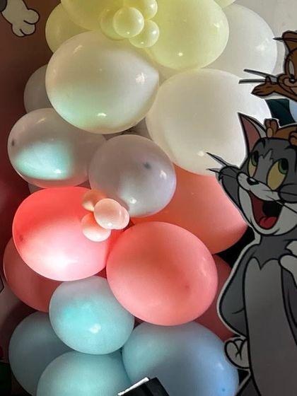 A detailed shot of a balloon column with a Tom and Jerry cutout prop, perfect for adding dimension to the party space.