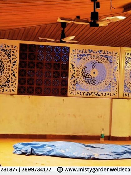 A nighttime view of the CNC designer panels, with backlighting that accentuates their intricate design. This shows how thoughtful lighting can turn a privacy screen into a stunning art piece.