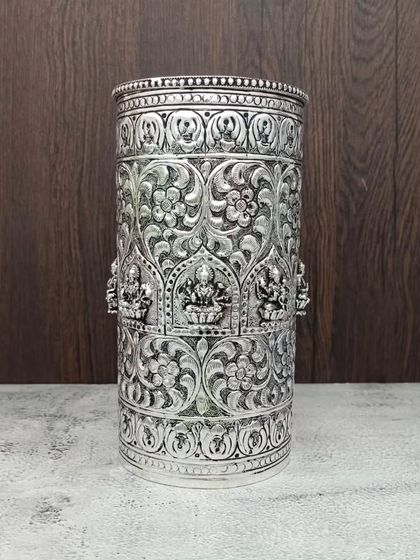 This antique German silver rice glass features detailed carvings of Goddess Lakshmi and floral patterns. It is a piece of art, handcrafted with love.