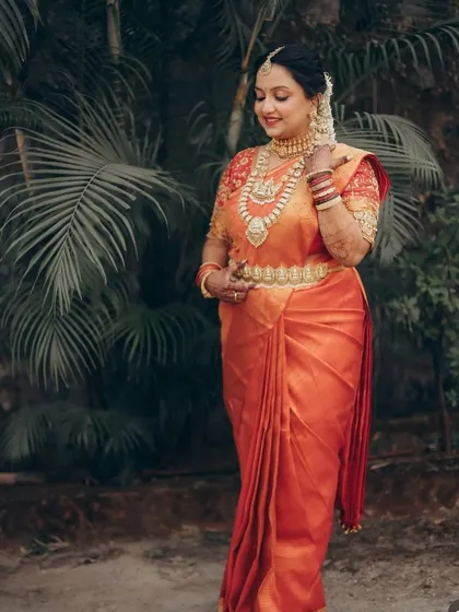 My bride Shreya in a beautiful orange Kanjivaram saree, looking like a classic South Indian goddess.