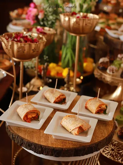 Mini wraps and other finger foods at a Diwali celebration. This shot focuses on the easy-to-eat, crowd-pleasing options perfect for a party.