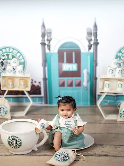 A giant cup of coffee for a tiny barista. This playful shot adds a fun twist to the Starbucks theme, showing the creative props we use to make shoots special.