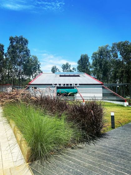 The Saritha Serene marketing office viewed from the outside, nestled in a landscape of ornamental grasses. This image shows how I use landscape to soften architecture and ground it in its natural context.