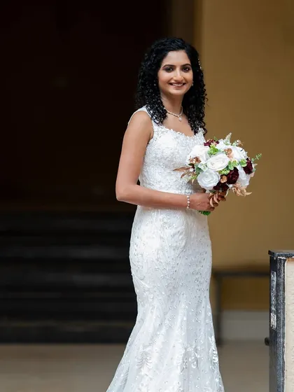 A full-length shot of this stunning bride. Her natural curls were styled to perfection, and her makeup was kept fresh and glowing.