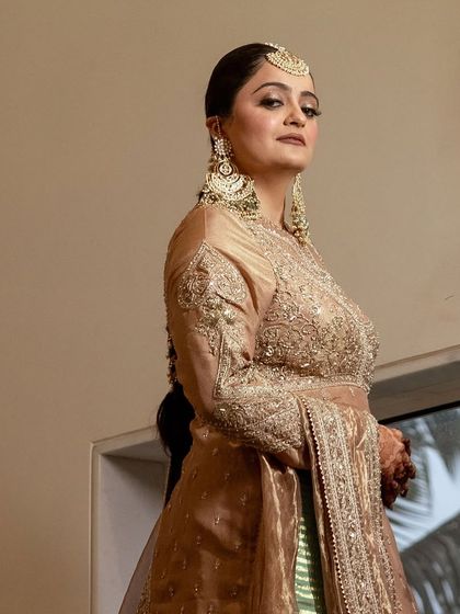 A powerful and poised shot of the bride. Her makeup is elegant and understated, letting her natural beauty and stunning outfit shine.