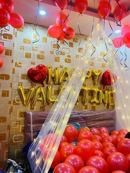 A closer view of the Valentine's Day decor, focusing on the glowing canopy and the abundance of red balloons creating a passionate atmosphere.