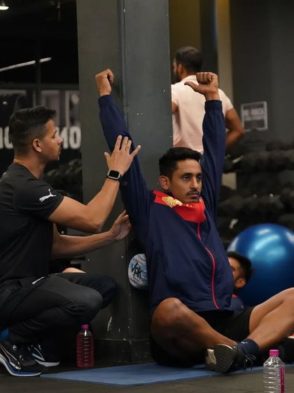 Staying true to the process. Here, I'm assisting an athlete with a wall-facing shoulder mobility drill, a critical exercise for overhead athletes to maintain shoulder health and function.