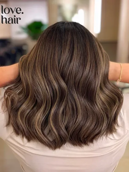 Dreaming of custard vanilla pies. This ash brown balayage on a chic bob was created with a bleach and tone process for a cool, sophisticated finish.