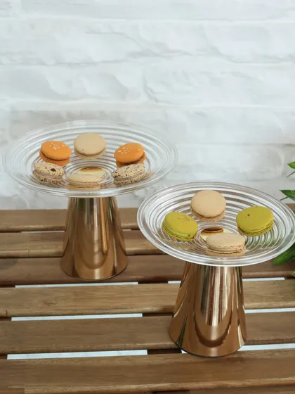 Our Vesper high tea stands, shown here serving colorful macarons. The reflective gold base and clear glass top make for a stunning presentation of delicate desserts.