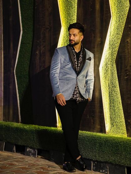 A client wearing a light blue velvet blazer with a printed shirt. This shows how our pieces can be styled for a more relaxed yet fashionable look.