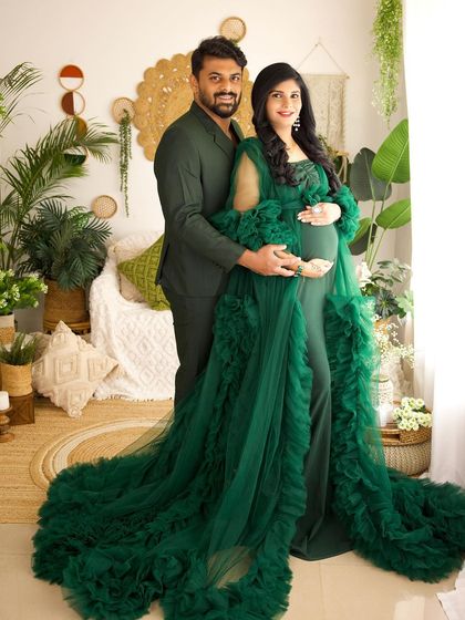 A glamorous couple's portrait in our boho studio. The rich emerald green of her gown and his matching suit create a perfectly coordinated and stylish image.