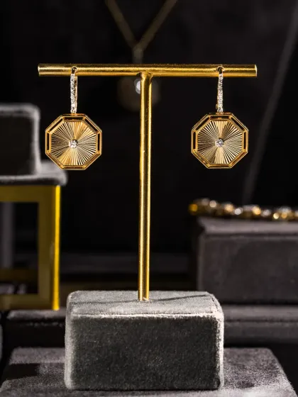 Some pieces don’t ask for attention, they earn it. These octagonal earrings from the Eternal Collection blend clean diamond geometry with intricate gold work, built for the woman who keeps her luxury subtle.