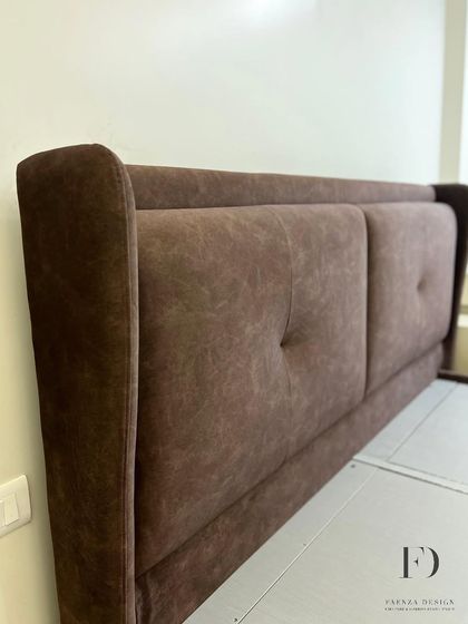 A custom bed with a winged, two-panel headboard in a rich brown fabric. The subtle tufting adds a touch of classic detail to this otherwise modern and comfortable design.