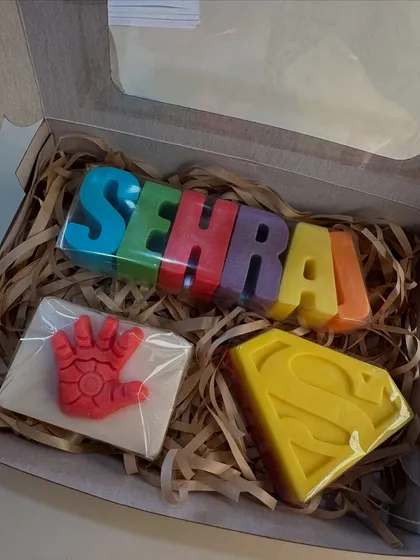 A superhero-themed gift box with a custom 'Sehrai' name soap, paired with Iron Man's hand and Superman's logo soaps.