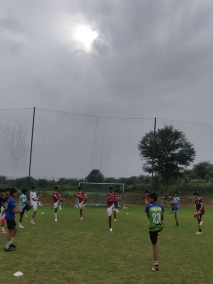 Players going through their warm-up stretches. Proper preparation is key to preventing injuries and ensuring peak performance during training.