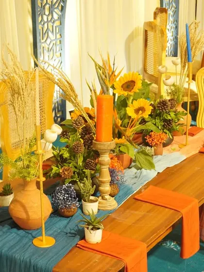 Table styling for our 'Moroccan Nightfall' event. We used a mix of sunflowers, dried wheat, and terracotta pots to create a rustic and earthy centerpiece.