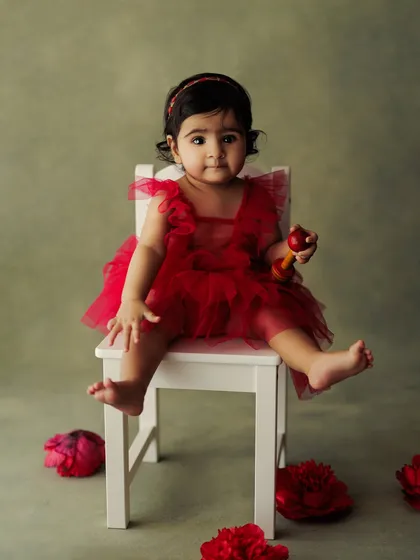 Dressed in a festive red dress, this little cupcake is ready for her close-up. Sitter sessions are perfect for capturing the budding personalities of babies around 6-9 months old.
