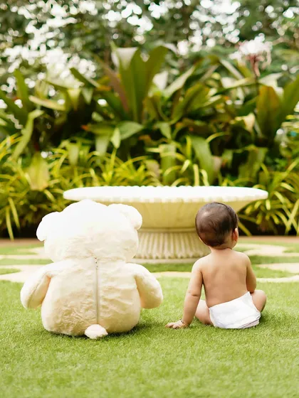 A simple, candid moment of a baby and his teddy bear enjoying a garden. Sometimes the best theme is just a quiet moment outdoors.