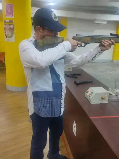 Actor Sachin Pilgaonkar taking his stance with an air rifle. We guide all our guests, including celebrities, to ensure a safe and enjoyable shooting session.