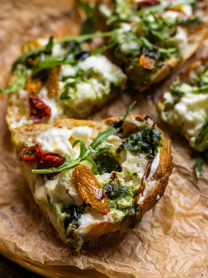 Slices of my bruschetta arranged on a platter, ready to be shared. The combination of crispy bread, creamy cheese, and fresh toppings makes this a crowd-pleasing favorite.