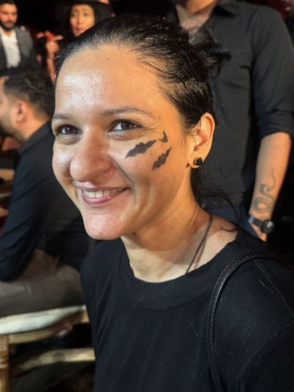 A simple yet classic Halloween look with three bats painted on the cheek. It's a quick and fun way to get into the spooky spirit.