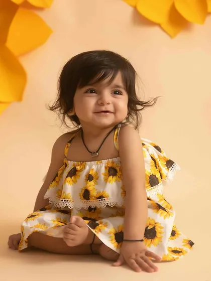 Another little ray of sunshine enjoying her sunflower-themed sitter session.