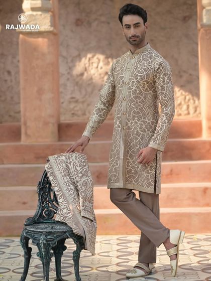 A creative pose showing the versatility of the Indo-Western set. The jacket can be removed for a more relaxed look, revealing the beautifully embroidered kurta underneath.