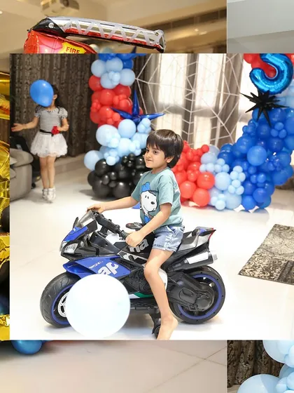 The birthday boy is ready to ride into his party. The decor in the background sets the scene for an epic celebration.