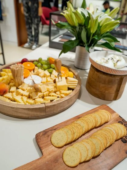 A minimalist and chic cheese board for the Paul Smith store event. The clean arrangement on a wooden platter complements the brand's sophisticated aesthetic.